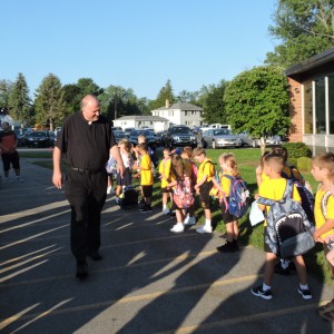 Father Gonyo welcoming the 1st graders.