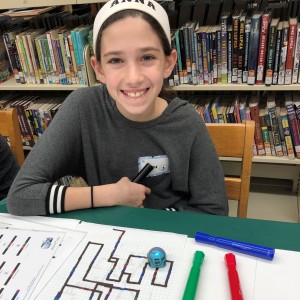 Watching her Ozobot follow the path she created.